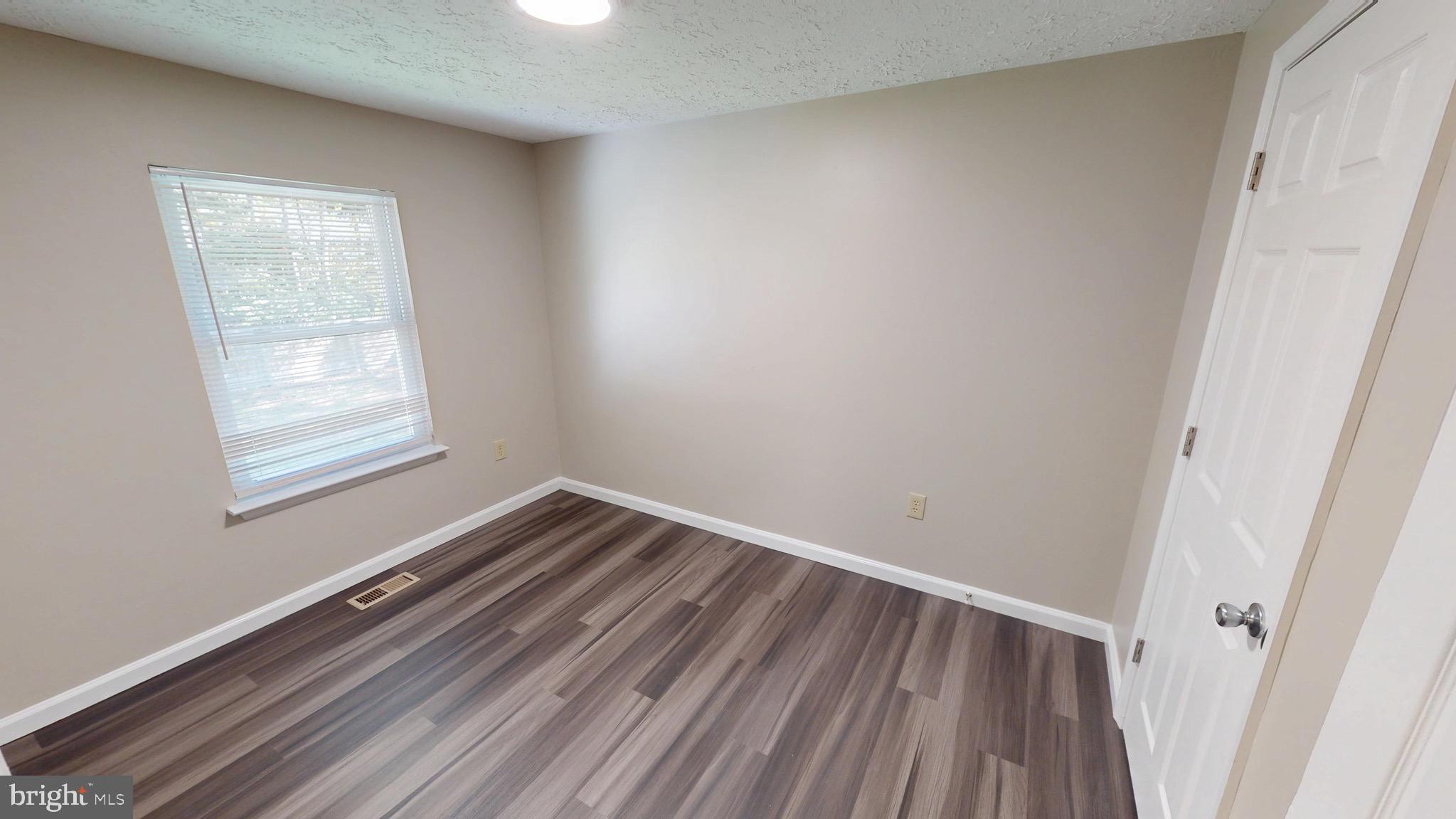12820 Twin Oak Drive Waldorf, MD 20601 - Photo 32 of 98 a view of a room with wooden floor and window