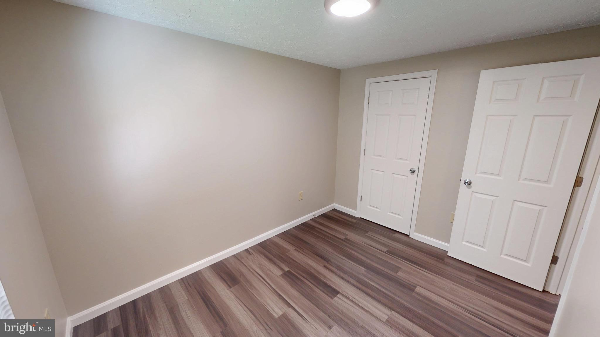 12820 Twin Oak Drive Waldorf, MD 20601 - Photo 33 of 98 a view of an empty room with wooden floor
