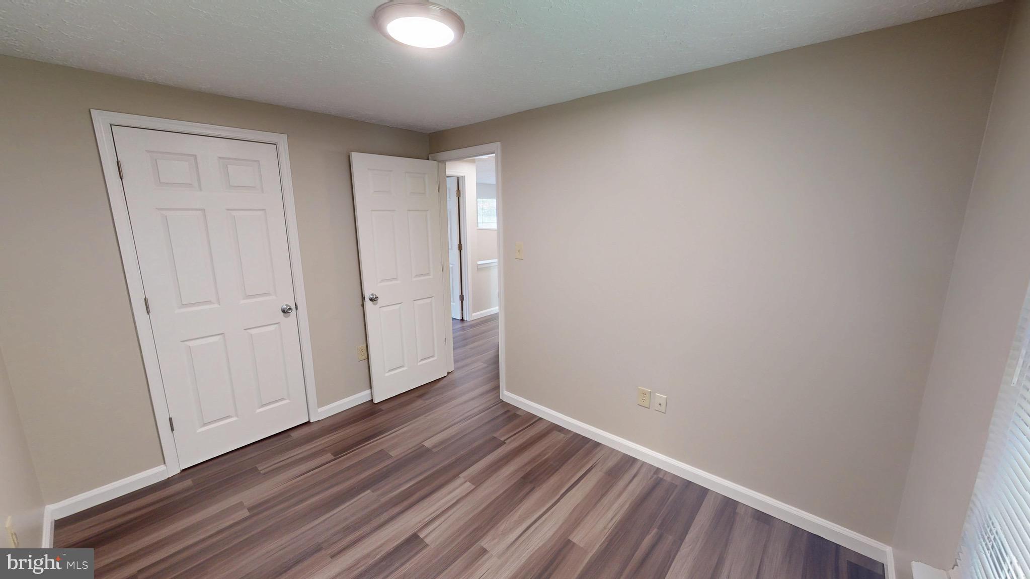 12820 Twin Oak Drive Waldorf, MD 20601 - Photo 34 of 98 a view of an empty room with closet and wooden floor