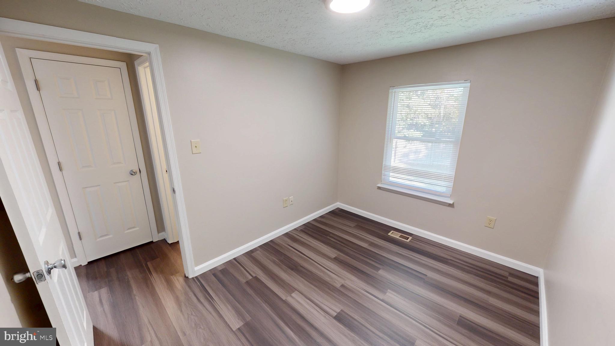 12820 Twin Oak Drive Waldorf, MD 20601 - Photo 35 of 98 an empty room with wooden floor and window