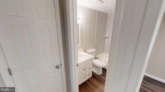 a view of walk in closet with wooden floor