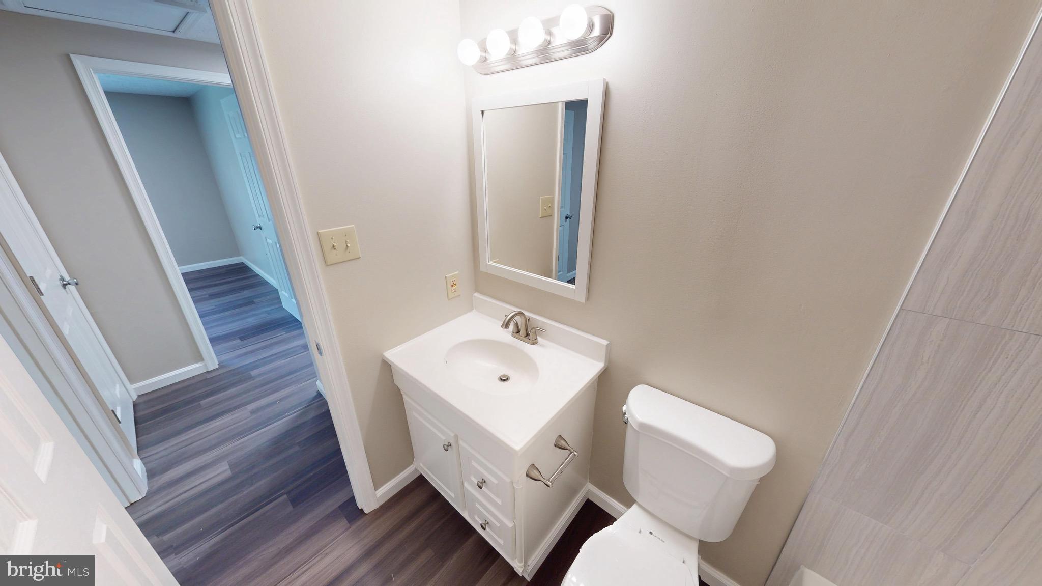 12820 Twin Oak Drive Waldorf, MD 20601 - Photo 38 of 98 a bathroom with a toilet a sink and mirror