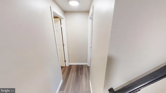 a view of hallway with wooden floor