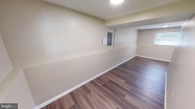 a view of living room with furniture and wooden floor