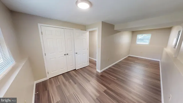 a view of a living room with furniture and wooden floor