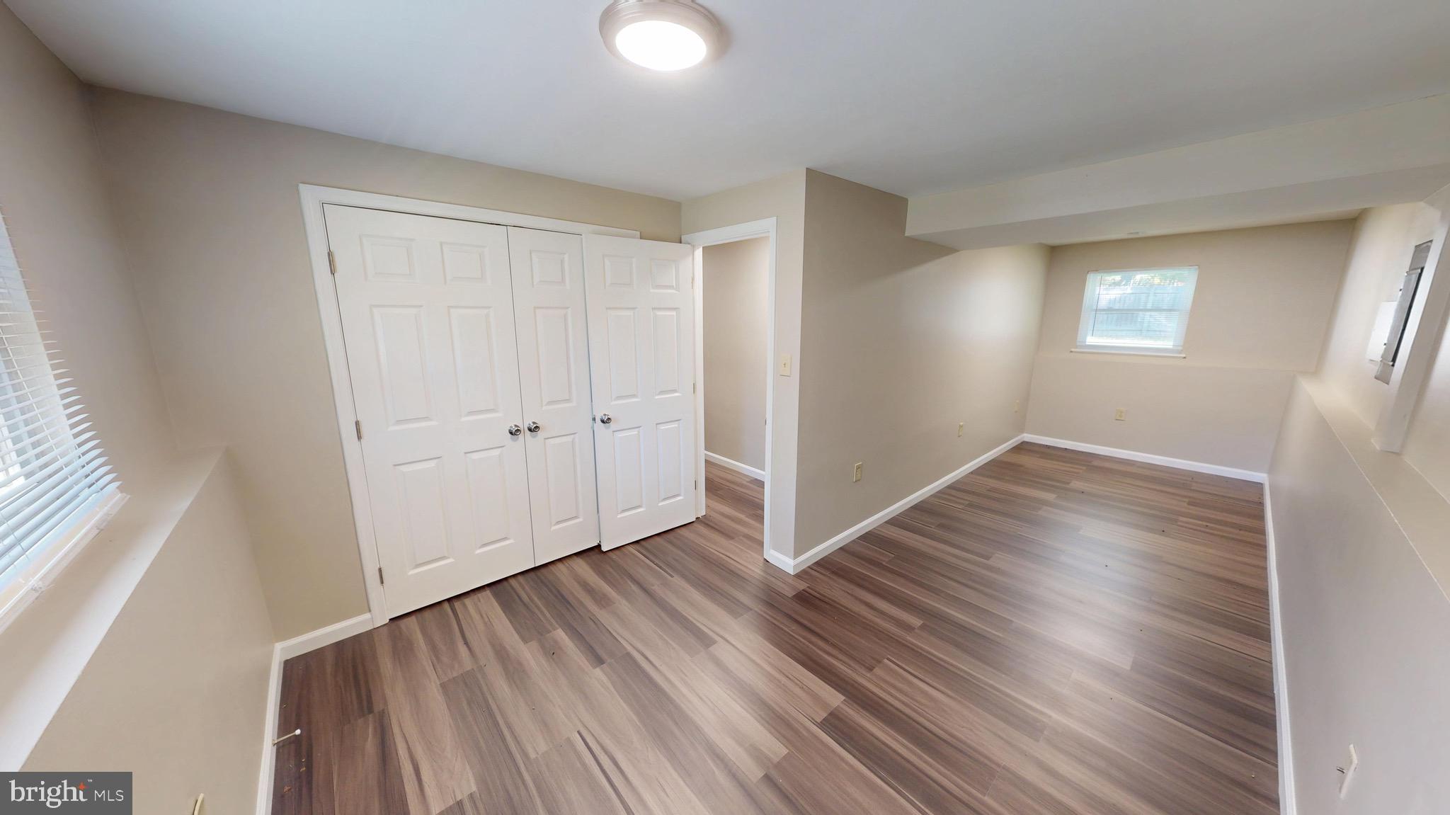 12820 Twin Oak Drive Waldorf, MD 20601 - Photo 50 of 98 a view of an empty room with wooden floor and a window