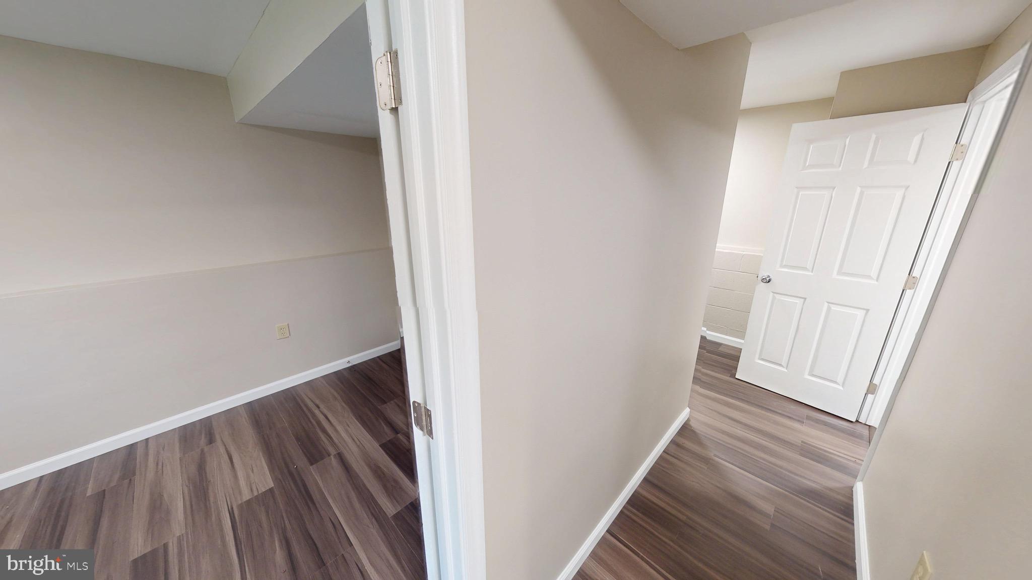 12820 Twin Oak Drive Waldorf, MD 20601 - Photo 60 of 98 a view of a hallway with wooden floor and staircase