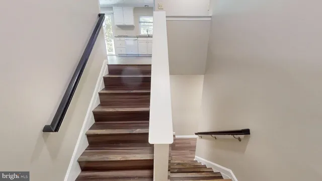 a view of entryway and gallery with wooden floor