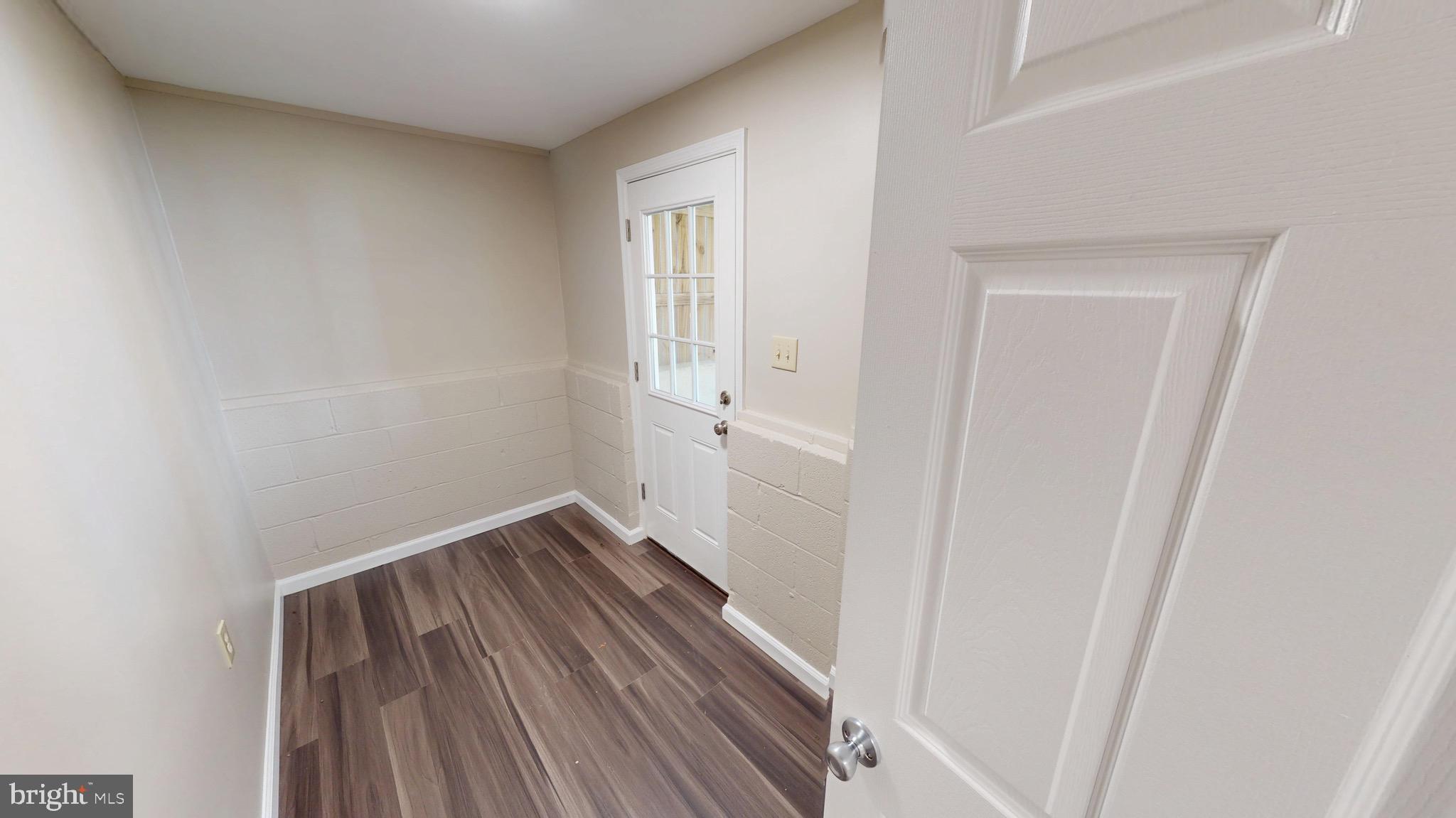 12820 Twin Oak Drive Waldorf, MD 20601 - Photo 66 of 98 a view of an empty room with wooden floor and a window