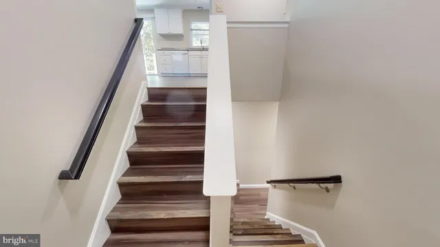 a view of entryway and gallery with wooden floor