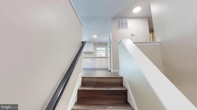 a view of entryway and hall with wooden floor