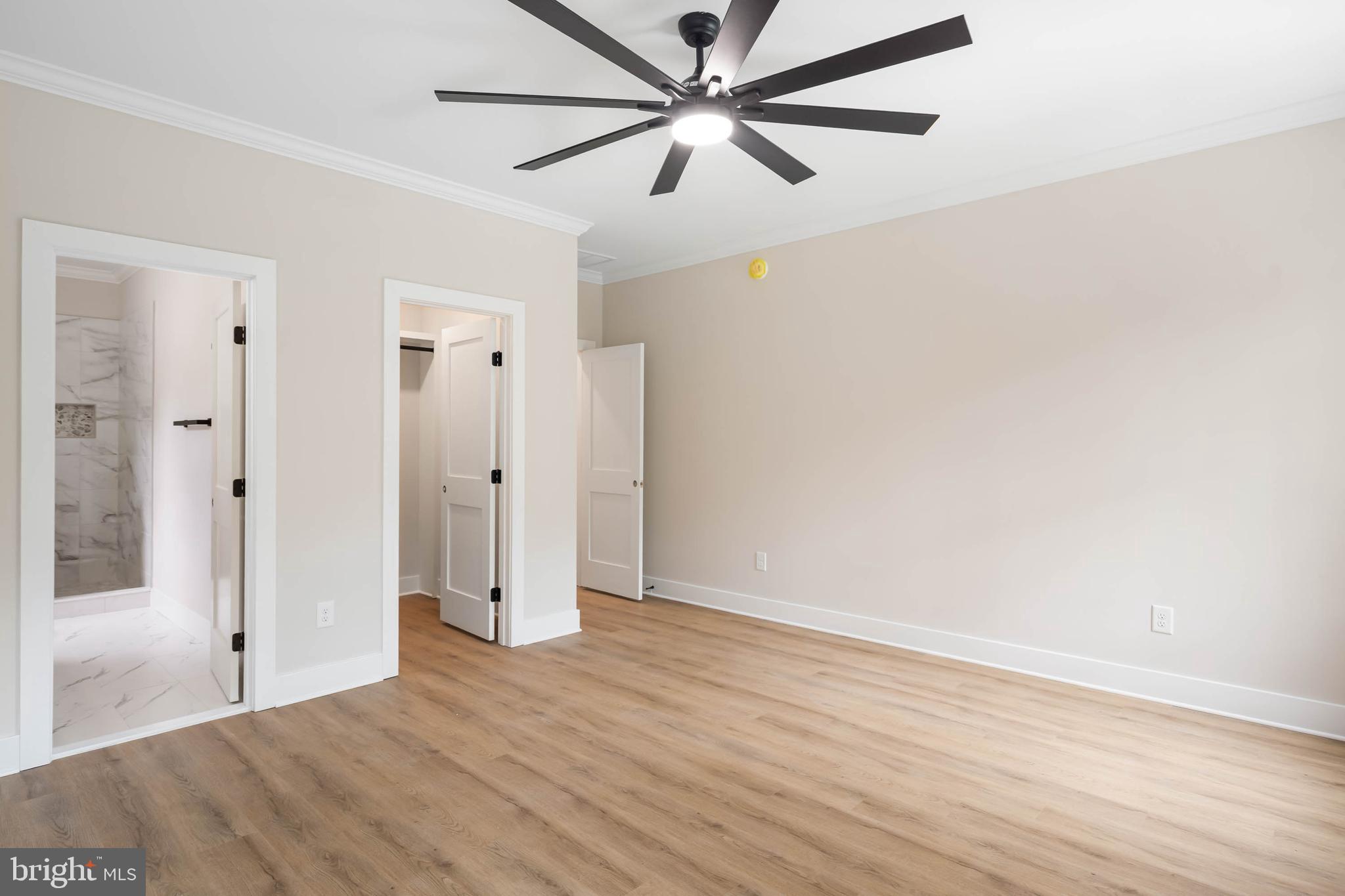 38697 Fred Hudson Road Bethany Beach, DE 19930 - Photo 45 of 51 an empty room with wooden floor and fan