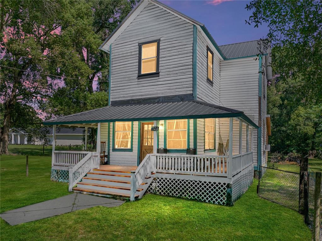 a view of a house with a yard and deck
