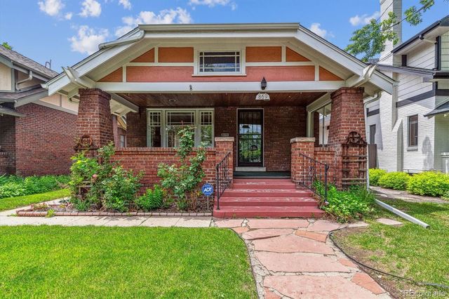a front view of a house with a yard balcony