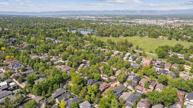 a view of a city with lush green forest