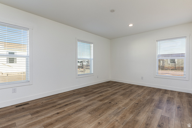 749 Riddle Drive Fredonia, AZ 86022 - Photo 24 of 41 Empty room with dark wood-style flooring and recessed lighting
