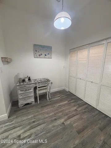 a view of a room with furniture and wooden floor