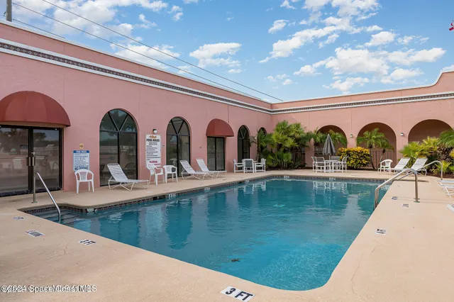 a view of swimming pool with outdoor seating