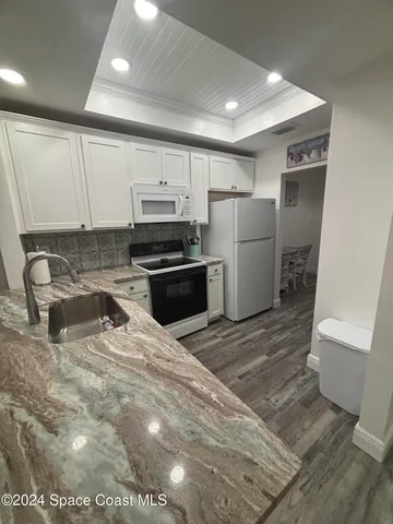 a kitchen with a refrigerator and a sink
