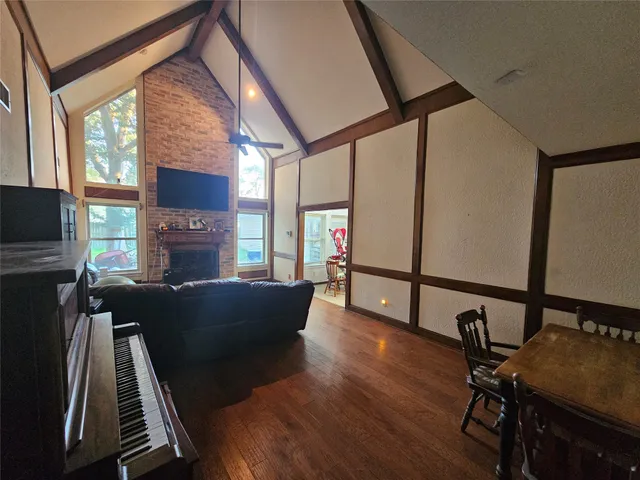 a living room with furniture fireplace and a flat screen tv