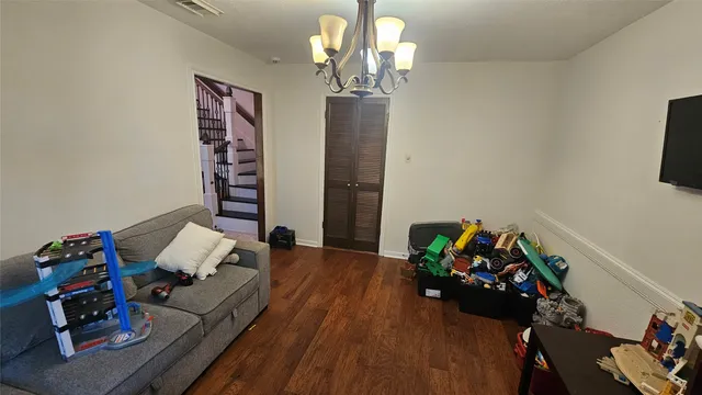 a bedroom with furniture and a wooden floor