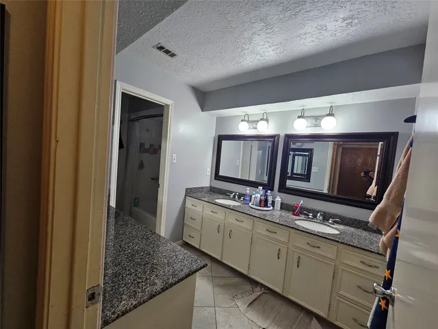 a kitchen with cabinets and flat screen tv