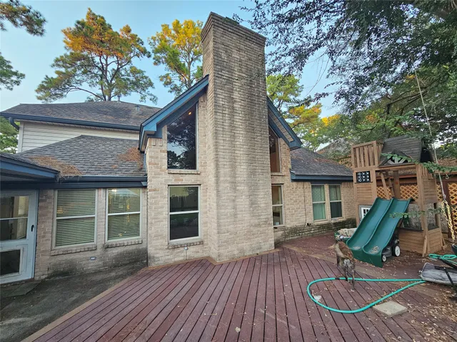 a view of backyard with table and chairs and wooden fence
