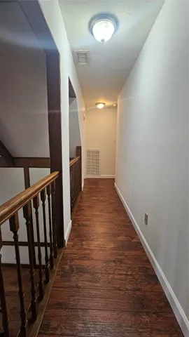 an entryway in a hall with wooden floor