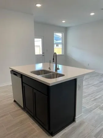 a kitchen with granite countertop a stove top oven a sink and dishwasher a refrigerator with wooden floors