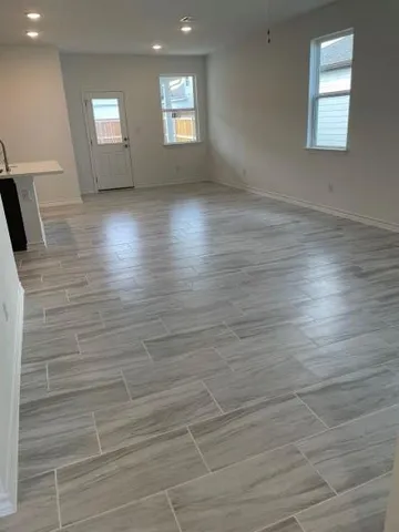 a view of a hallway with a kitchen
