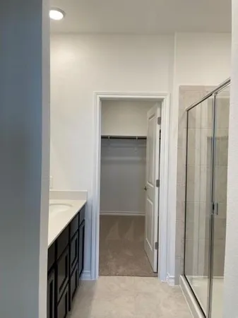 a bathroom with a shower and a sink