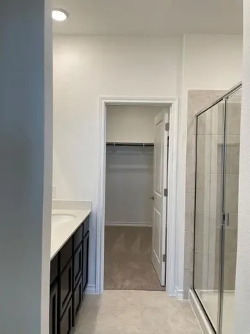 a bathroom with a shower and a sink