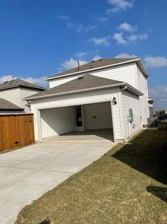 an empty room with windows and chandelier fan