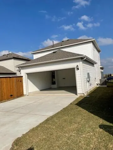 an empty room with windows and chandelier fan