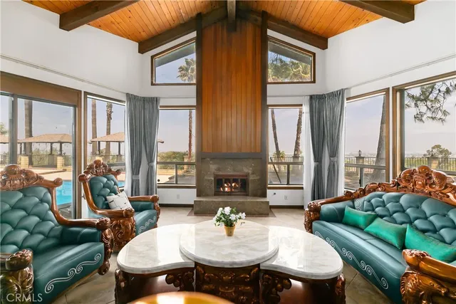 a living room with fireplace furniture and a floor to ceiling window