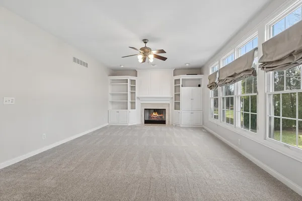 a dining room with furniture a chandelier and wooden floor