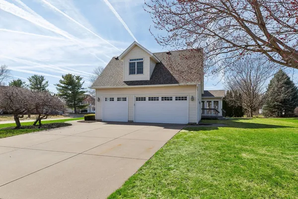 a view of a house with a yard and garage