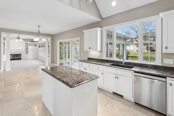 a bathroom with a tub a sink and a window