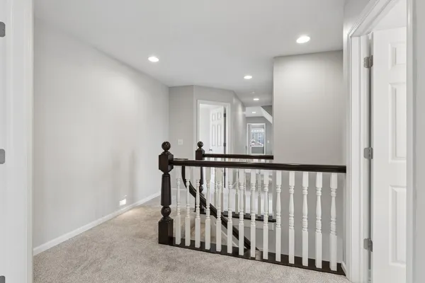 a spacious bathroom with a double vanity sink a large mirror and a shower
