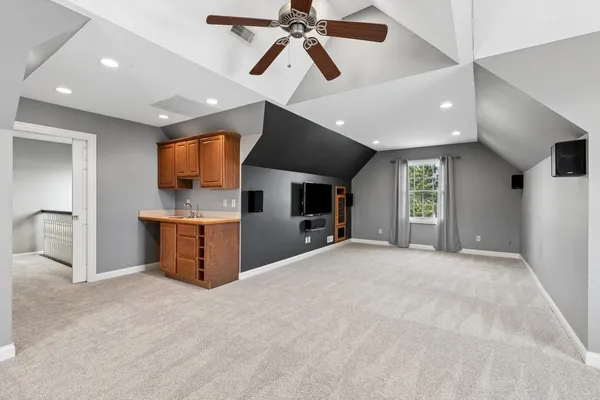 a view of empty room with wooden floor and window