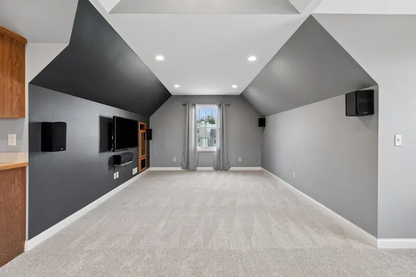 an empty room with wooden floor and fireplace
