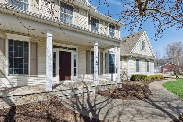 front view of a brick house with a yard