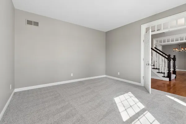 a view of a livingroom with wooden floor and a chandelier