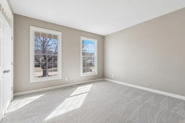 a view of a room with wooden floor staircase and a chandelier