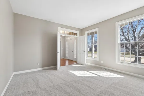 a view of a hallway with wooden floor and staircase