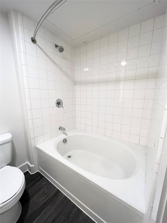 6080 Water Street, Unit 1462 Plano, TX 75024 - Photo 6 of 9 a white bath tub sitting next to a white toilet and a sink