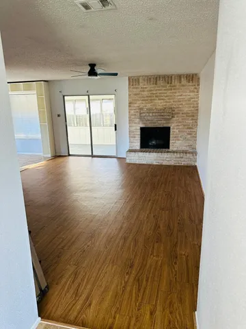 wooden floor in an empty room with a fireplace