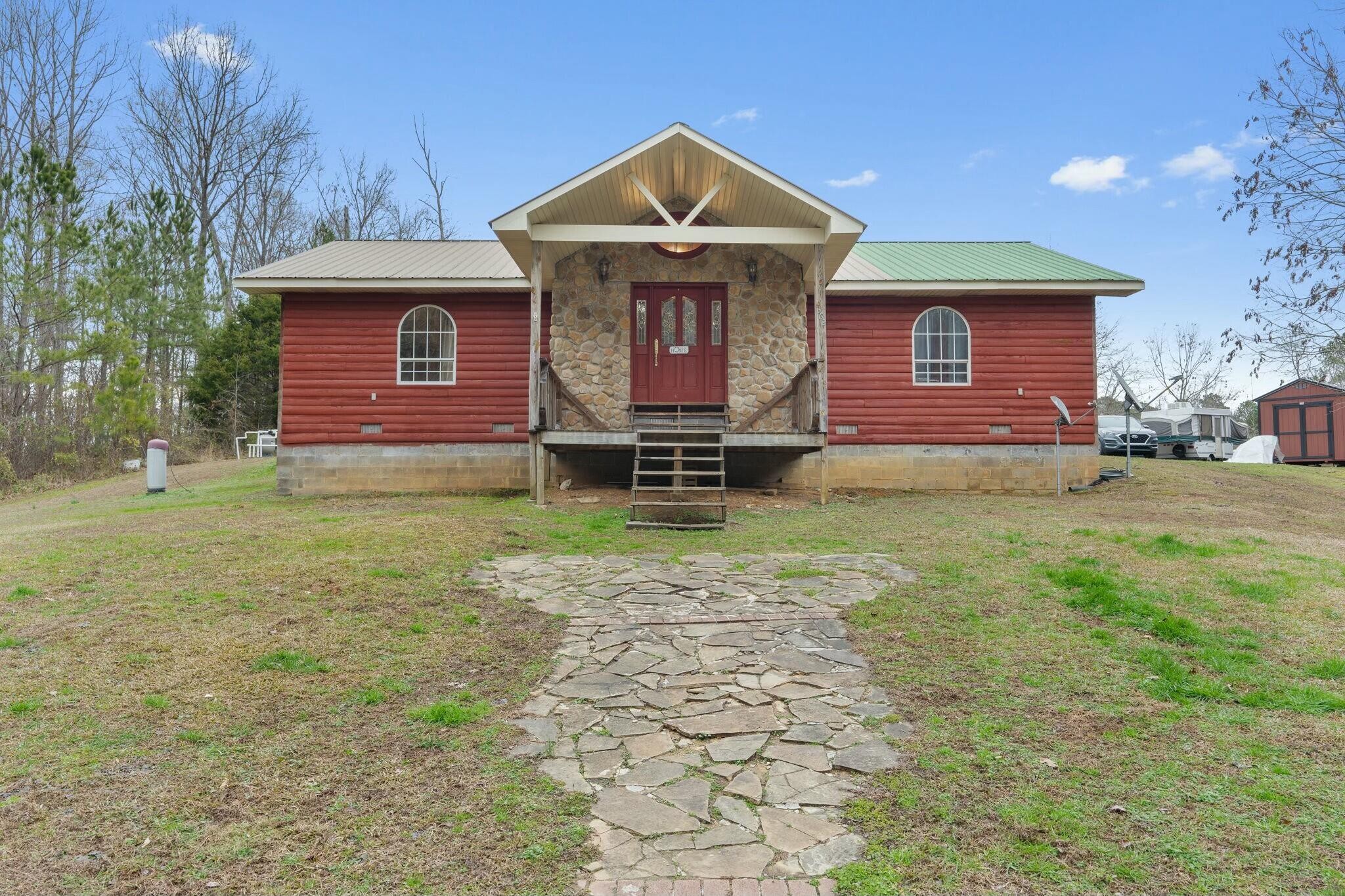 a front view of a house with garden