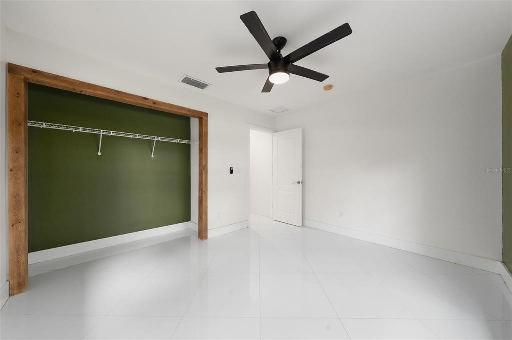 11036 Bronson Road Clermont, FL 34711 - Photo 14 of 29 an empty room with closet and windows