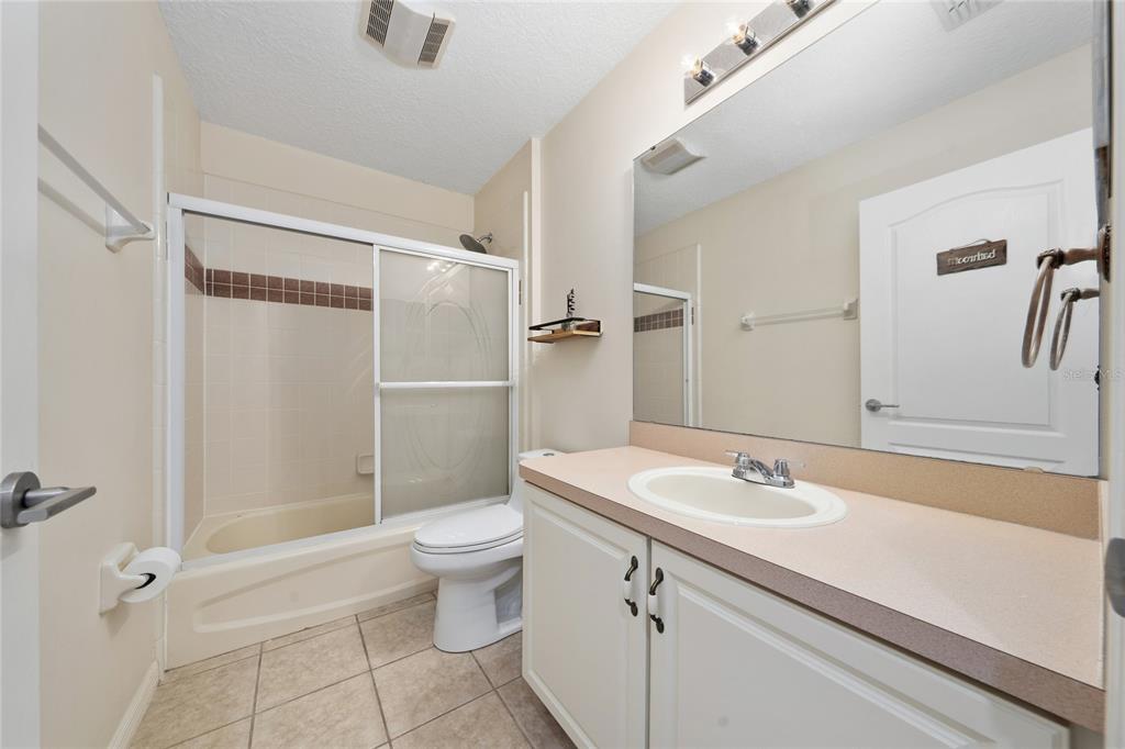 11036 Bronson Road Clermont, FL 34711 - Photo 15 of 29 a bathroom with a sink toilet and shower